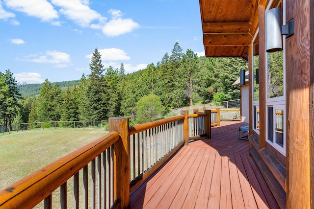956 Falling Star Rd, Victor, MT 59875 - wooden terrace featuring a wooded view