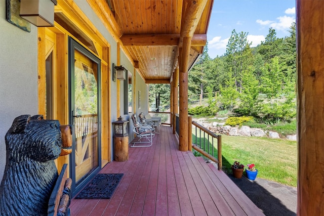 956 Falling Star Rd, Victor, MT 59875 - wooden porch with a lawn and a view of trees