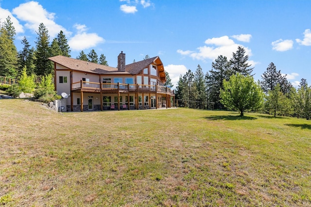 956 Falling Star Rd, Victor, MT 59875 - back of property featuring a deck, a chimney, a lawn, and stucco siding