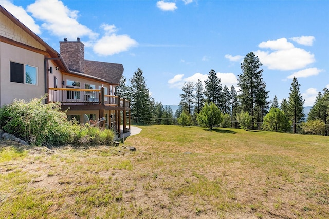 956 Falling Star Rd, Victor, MT 59875 - view of green lawn with a wooden deck