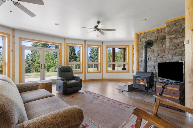 956 Falling Star Rd, Victor, MT 59875 - living room with ceiling fan, a wood stove, wood finished floors, french doors, and recessed lighting