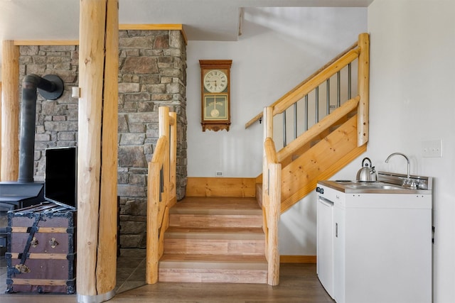 956 Falling Star Rd, Victor, MT 59875 - staircase featuring wood finished floors and a wood stove