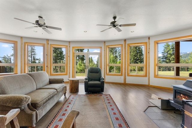 956 Falling Star Rd, Victor, MT 59875 - living room with a wood stove, a ceiling fan, plenty of natural light, and recessed lighting