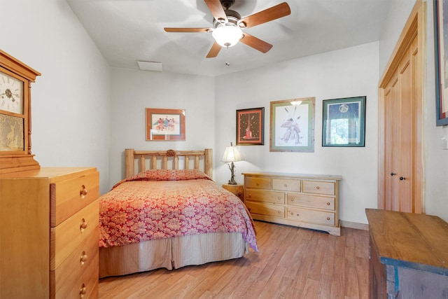 956 Falling Star Rd, Victor, MT 59875 - bedroom with light wood-style floors, a ceiling fan, and a closet