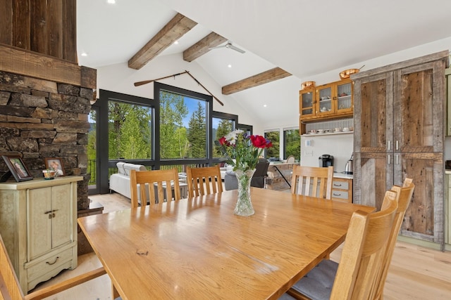 103 Glacier Hills Dr E, Martin City, MT 59926 - dining area featuring beamed ceiling, a fireplace, light wood-style floors, high vaulted ceiling, and recessed lighting