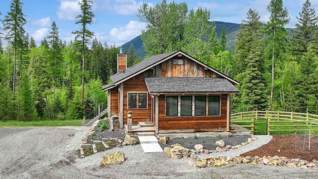 103 Glacier Hills Dr E, Martin City, MT 59926 - chalet / cabin featuring a chimney and a wooded view