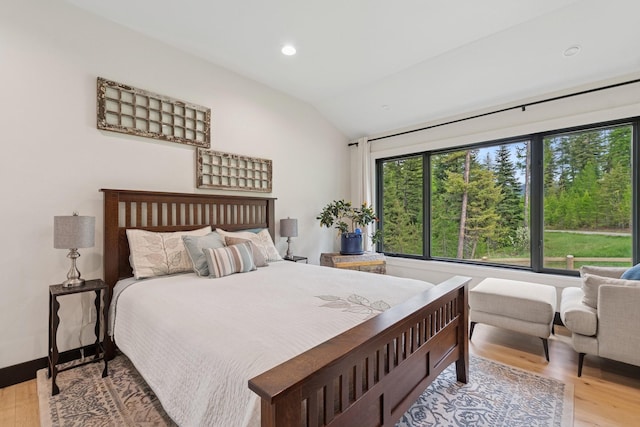 103 Glacier Hills Dr E, Martin City, MT 59926 - bedroom featuring vaulted ceiling, wood finished floors, and recessed lighting