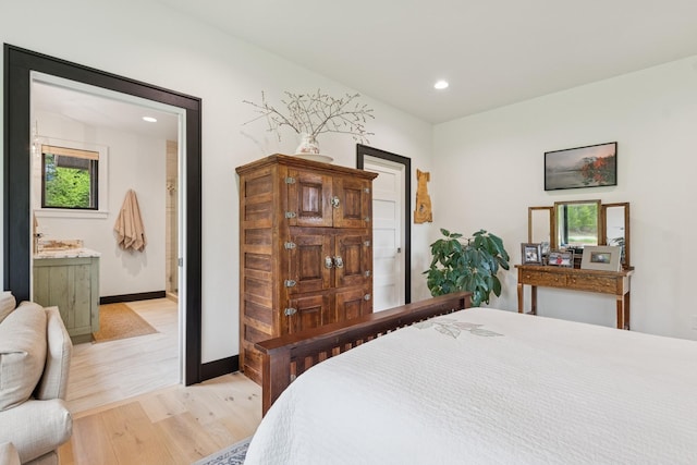 103 Glacier Hills Dr E, Martin City, MT 59926 - bedroom with light wood finished floors, baseboards, recessed lighting, and multiple windows