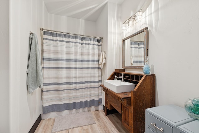 103 Glacier Hills Dr E, Martin City, MT 59926 - bathroom featuring wood finished floors, vanity, and a shower with shower curtain
