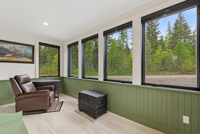 103 Glacier Hills Dr E, Martin City, MT 59926 - sunroom / solarium featuring wood finished floors and a wainscoted wall