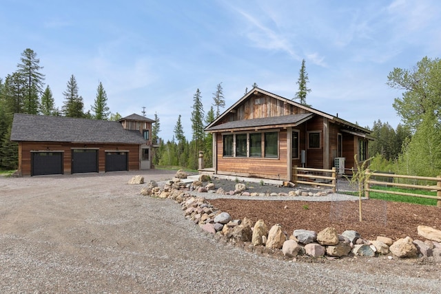 103 Glacier Hills Dr E, Martin City, MT 59926 - rustic home featuring an outbuilding, a garage, and dirt driveway