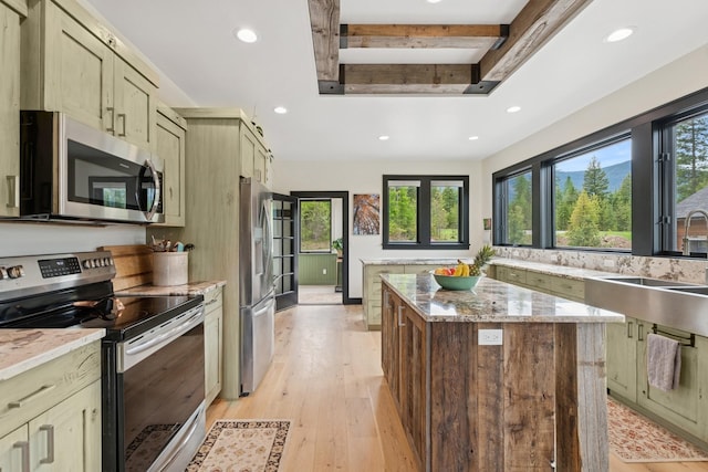 103 Glacier Hills Dr E, Martin City, MT 59926 - kitchen featuring stainless steel appliances, a sink, plenty of natural light, recessed lighting, and a center island