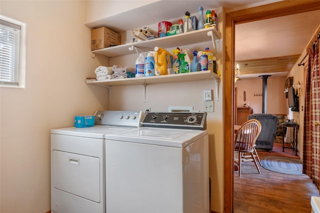 18711 Copper Ridge Trl, Florence, MT 59833 - laundry area with washing machine and dryer, a wood stove, and wood finished floors