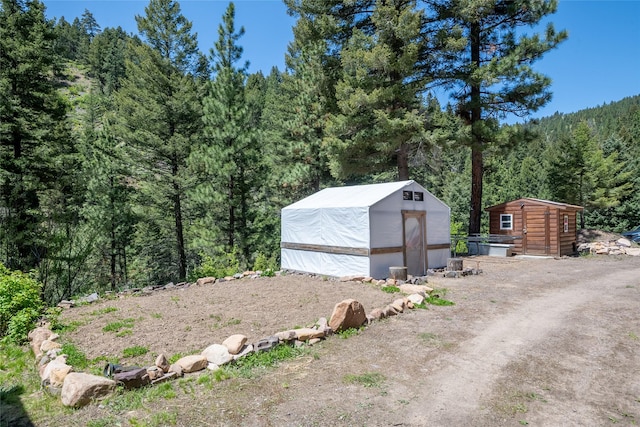 18711 Copper Ridge Trl, Florence, MT 59833 - view of greenhouse with a forest view