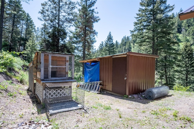 18711 Copper Ridge Trl, Florence, MT 59833 - view of poultry coop featuring a forest view