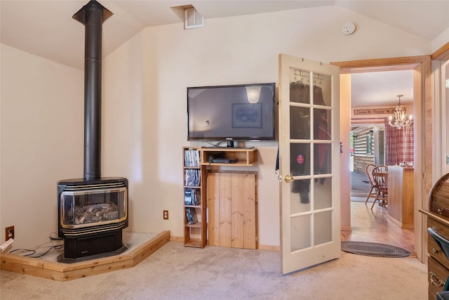 18711 Copper Ridge Trl, Florence, MT 59833 - living room with a wood stove, lofted ceiling, carpet, and a chandelier