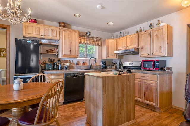 18711 Copper Ridge Trl, Florence, MT 59833 - kitchen featuring black dishwasher, stainless steel stove, under cabinet range hood, a sink, and refrigerator