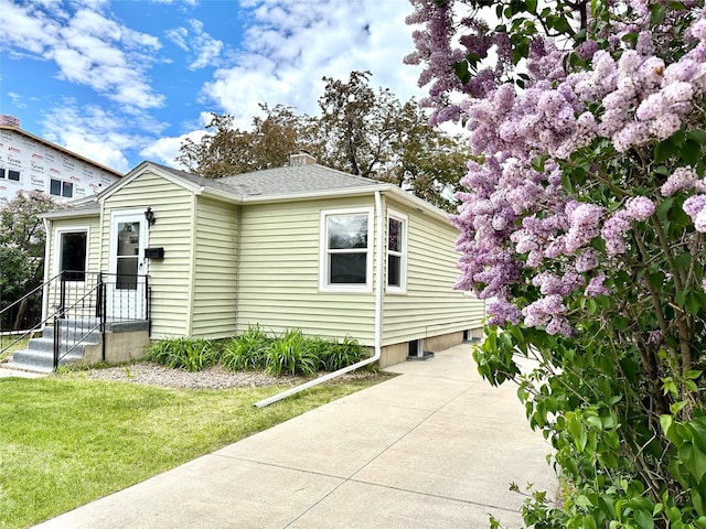 2513 8th Ave N, Great Falls, MT 59401 - view of front of property with a shingled roof, a front lawn, a chimney, and concrete driveway