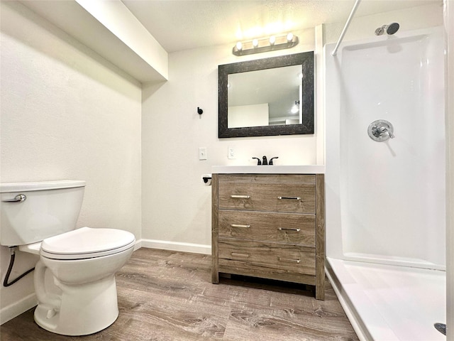 2513 8th Ave N, Great Falls, MT 59401 - full bathroom with a shower, vanity, wood finished floors, baseboards, and toilet