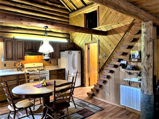 7191 Boy Scout Rd, Seeley Lake, MT 59868 - dining space featuring wood walls, wood finished floors, and wood ceiling