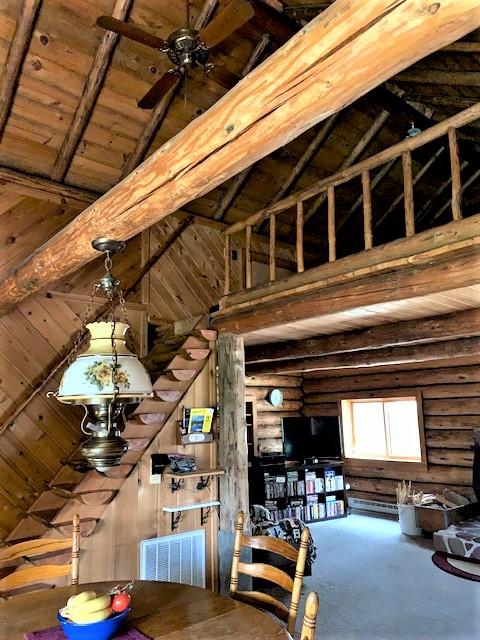 7191 Boy Scout Rd, Seeley Lake, MT 59868 - dining room with high vaulted ceiling, beamed ceiling, and log walls