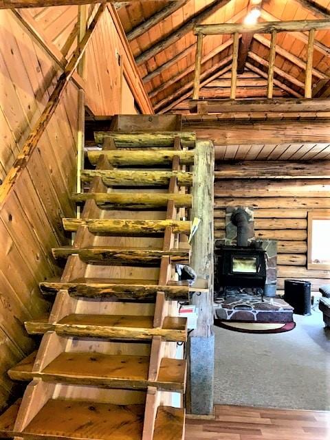 7191 Boy Scout Rd, Seeley Lake, MT 59868 - stairs featuring a wood stove, wood finished floors, and wood ceiling
