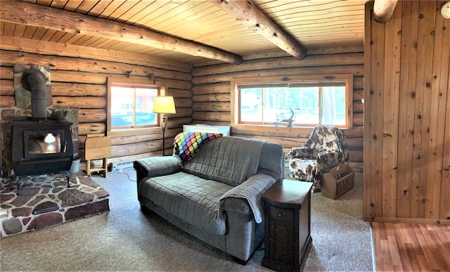7191 Boy Scout Rd, Seeley Lake, MT 59868 - living room with a wood stove, wooden ceiling with exposed beams, log walls, and carpet flooring