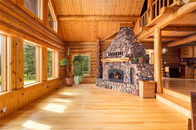 1473 Foothill Rd, Kalispell, MT 59901 - unfurnished living room featuring rustic walls, wood ceiling, wood finished floors, and a fireplace