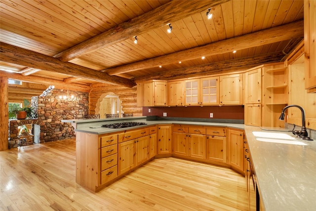 1473 Foothill Rd, Kalispell, MT 59901 - kitchen featuring a peninsula, light wood finished floors, rustic walls, gas cooktop, and a wooden ceiling with exposed beams