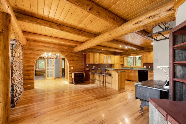 1473 Foothill Rd, Kalispell, MT 59901 - kitchen featuring arched walkways, black dishwasher, open shelves, a breakfast bar area, and a wooden ceiling with exposed beams