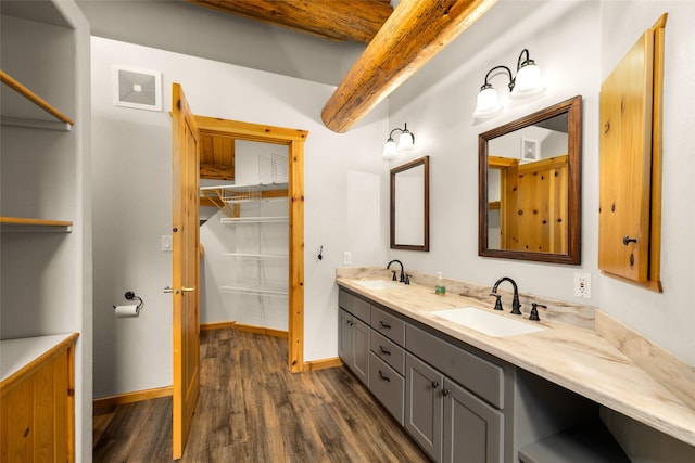 1473 Foothill Rd, Kalispell, MT 59901 - bathroom featuring wood finished floors, double vanity, and a walk in closet