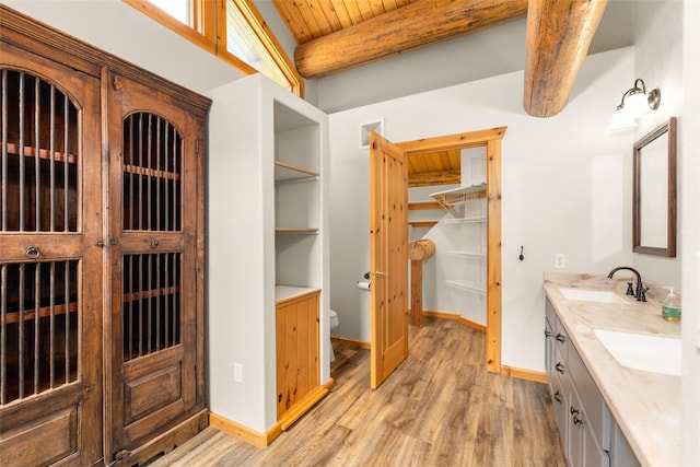 1473 Foothill Rd, Kalispell, MT 59901 - full bath with double vanity, a wooden ceiling with exposed beams, wood finished floors, and a walk in closet