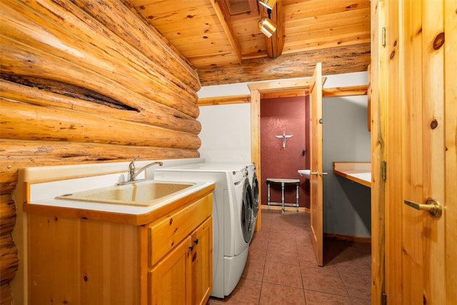 1473 Foothill Rd, Kalispell, MT 59901 - laundry area featuring wooden ceiling, washing machine and clothes dryer, rustic walls, light tile patterned floors, and cabinet space