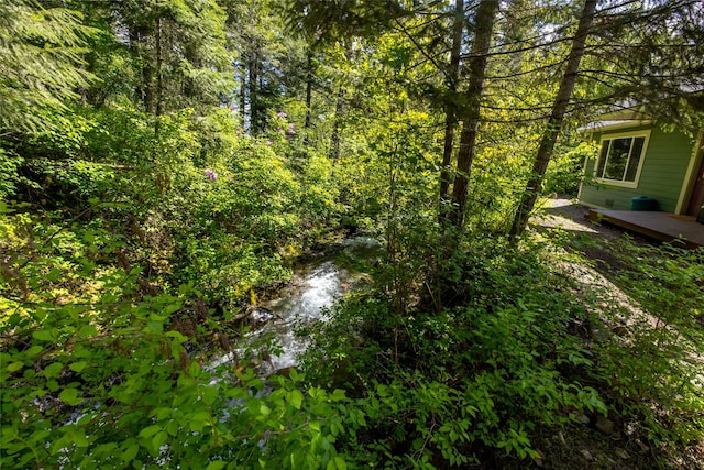 1473 Foothill Rd, Kalispell, MT 59901 - view of yard featuring a forest view and a deck
