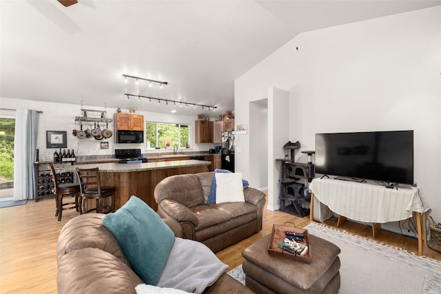 1473 Foothill Rd, Kalispell, MT 59901 - living room featuring light wood-style flooring, vaulted ceiling, track lighting, and ceiling fan