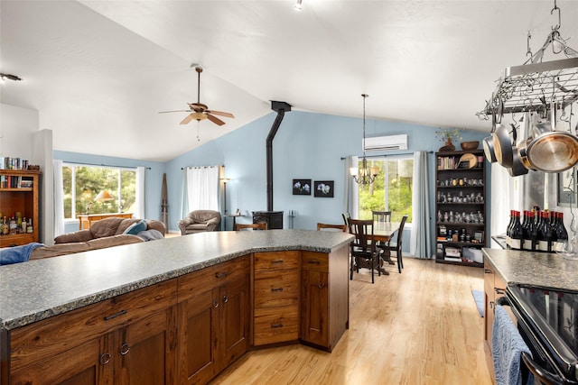 1473 Foothill Rd, Kalispell, MT 59901 - kitchen with lofted ceiling, black / electric stove, dark countertops, light wood-type flooring, and ceiling fan