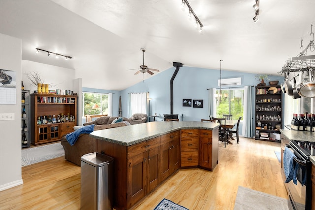 1473 Foothill Rd, Kalispell, MT 59901 - kitchen with rail lighting, black electric range, plenty of natural light, ceiling fan, and vaulted ceiling