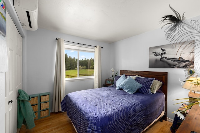 1473 Foothill Rd, Kalispell, MT 59901 - bedroom with an AC wall unit and wood finished floors