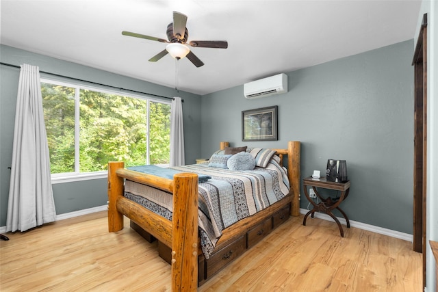 1473 Foothill Rd, Kalispell, MT 59901 - bedroom with a wall unit AC, light wood-style floors, and a ceiling fan