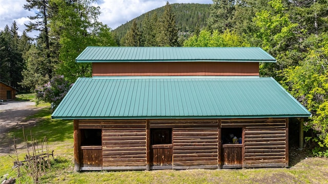 1473 Foothill Rd, Kalispell, MT 59901 - view of outbuilding with an exterior structure, a mountain view, and a forest view