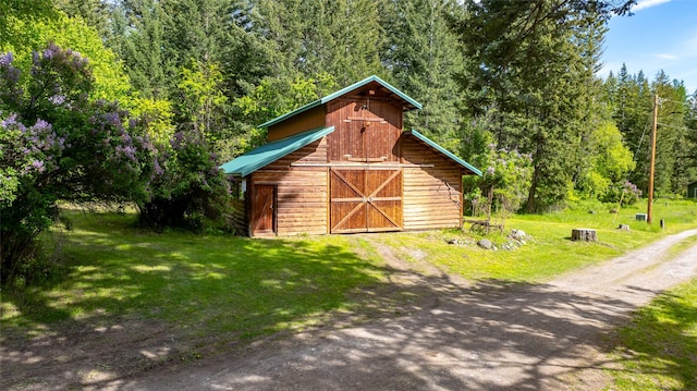 1473 Foothill Rd, Kalispell, MT 59901 - view of barn with a yard and a view of trees