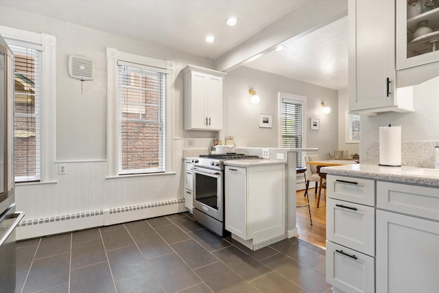 322 W Lawrence St, Helena, MT 59601 - kitchen with stainless steel stove, a baseboard radiator, a peninsula, white cabinetry, and light stone counters