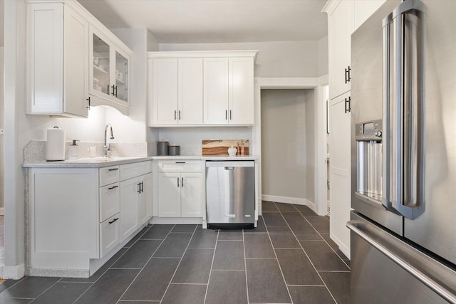 322 W Lawrence St, Helena, MT 59601 - kitchen with appliances with stainless steel finishes, a sink, white cabinets, glass insert cabinets, and dark tile patterned flooring