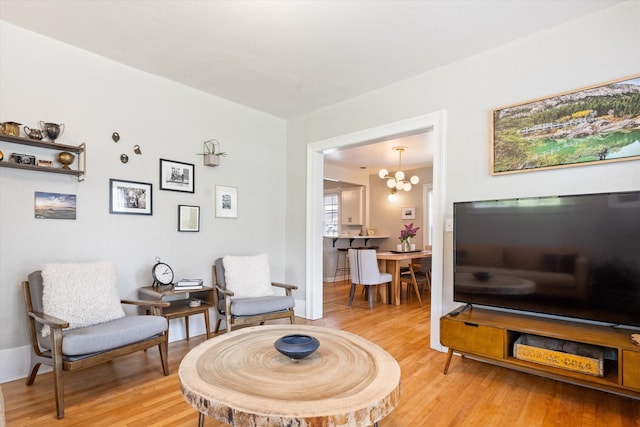 322 W Lawrence St, Helena, MT 59601 - living area featuring light wood finished floors, a chandelier, and baseboards