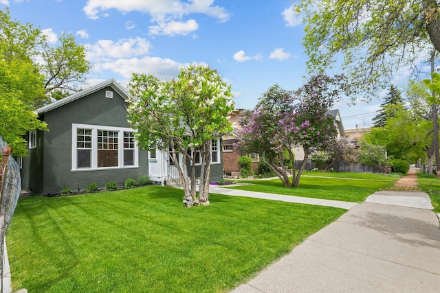 322 W Lawrence St, Helena, MT 59601 - view of front of house featuring a front yard and stucco siding