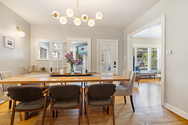 322 W Lawrence St, Helena, MT 59601 - dining area featuring light wood-type flooring, a chandelier, and baseboards