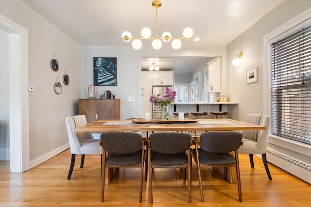322 W Lawrence St, Helena, MT 59601 - dining space with a baseboard heating unit, healthy amount of natural light, light wood finished floors, and baseboards