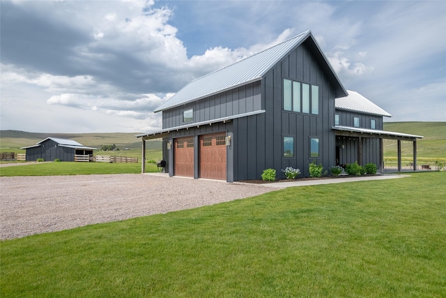 42730 Ridgeway Rd, Charlo, MT 59824 - view of front of home with board and batten siding, driveway, and a front yard