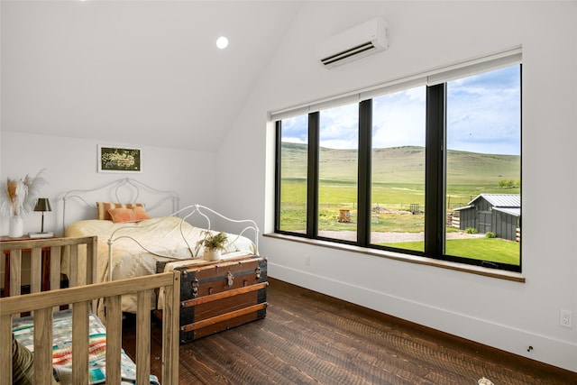 42730 Ridgeway Rd, Charlo, MT 59824 - bedroom with an AC wall unit, lofted ceiling, baseboards, dark wood-style floors, and recessed lighting