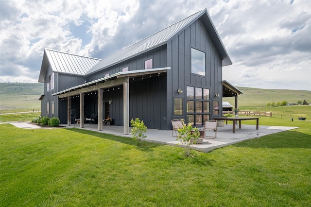 42730 Ridgeway Rd, Charlo, MT 59824 - rear view of house with a patio area, board and batten siding, a yard, and metal roof
